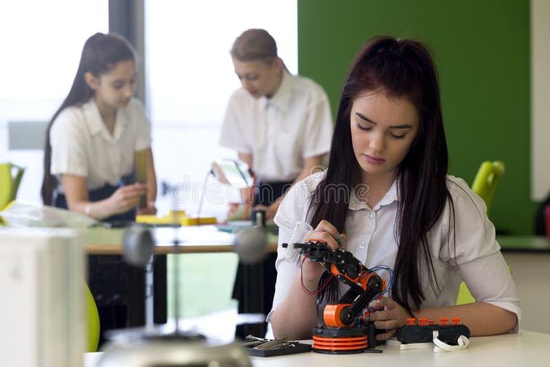 Teenage Girl Working on Robotic Arm royalty free stock images Teenage Girl Working on Robotic Arm royalty free stock images