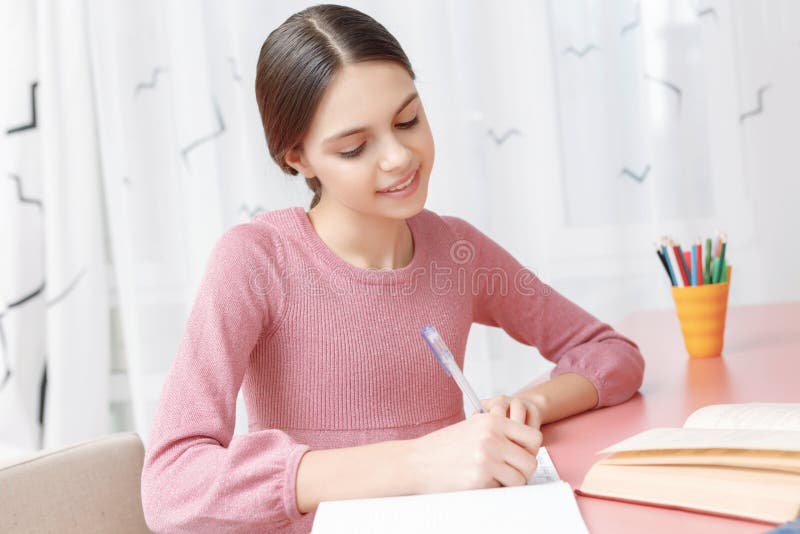 Teenage girl writing in her exercise book royalty free stock image Teenage girl writing in her exercise book royalty free stock image