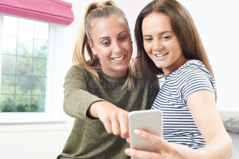 Teenage Girls Reading Text Message on Mobile Phone Stock Image - Image ...
