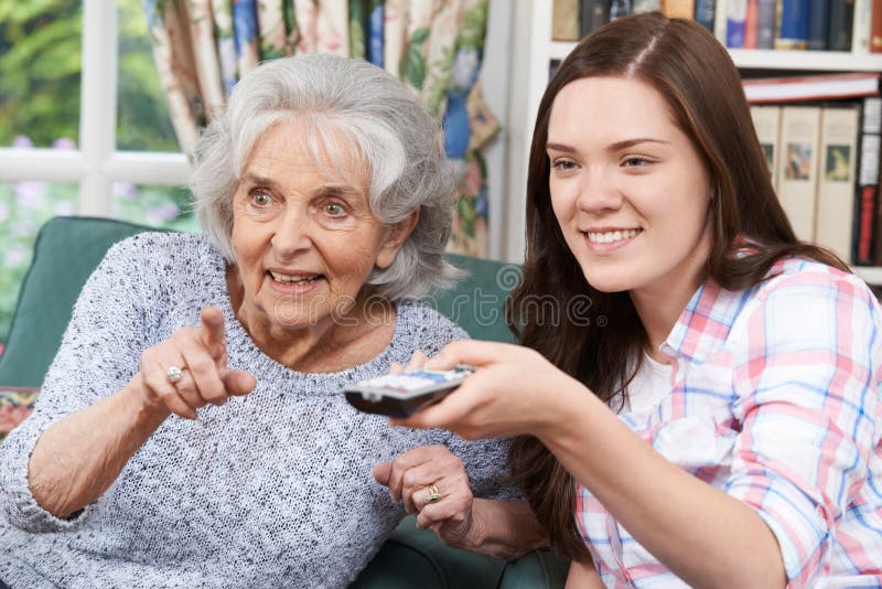 Teenage Granddaughter Watching Television With Grandmother royalty free stock photo Teenage Granddaughter Watching Television With Grandmother royalty free stock photo