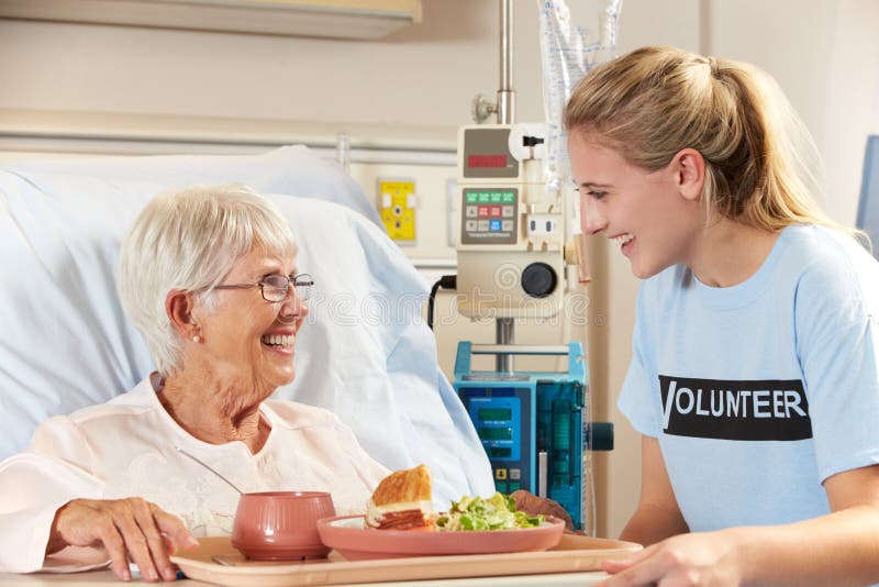 Teenage Volunteer Serving Senior Female Patient Meal royalty free stock photos Teenage Volunteer Serving Senior Female Patient Meal royalty free stock photos