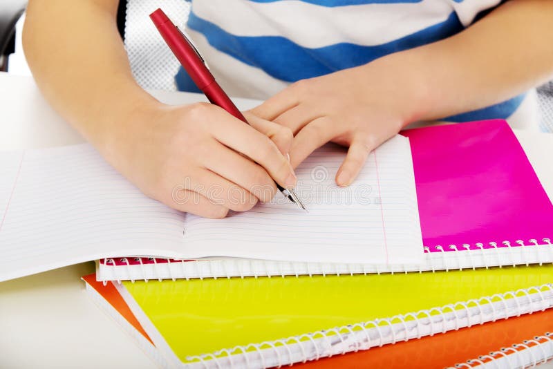Teenage woman hand doing a homework stock photos
