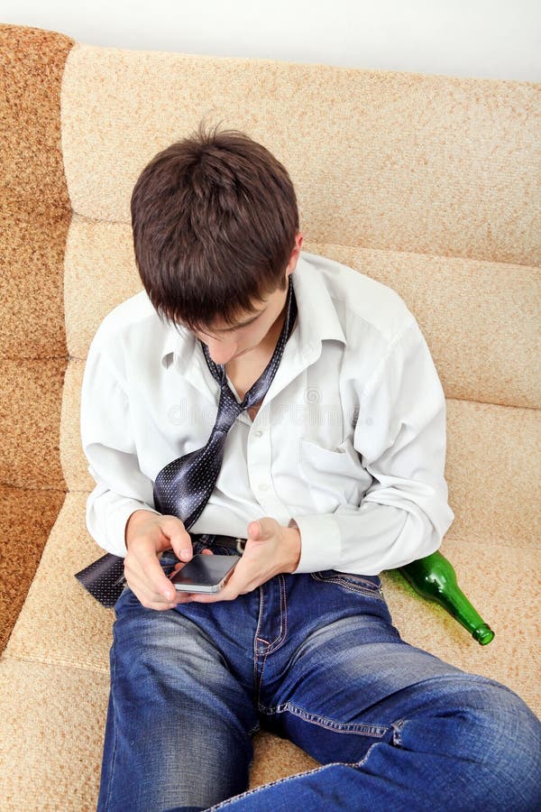 Teenager with a Beer and Cellphone Stock Photo Image of home, addict