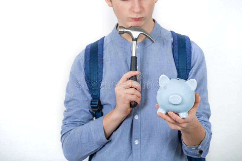 Teenager boy holding hammer and piggy bank thinking to spend his savings over white background. Financial education savings royalty free stock images Teenager boy holding hammer and piggy bank thinking to spend his savings over white background. Financial education savings royalty free stock images