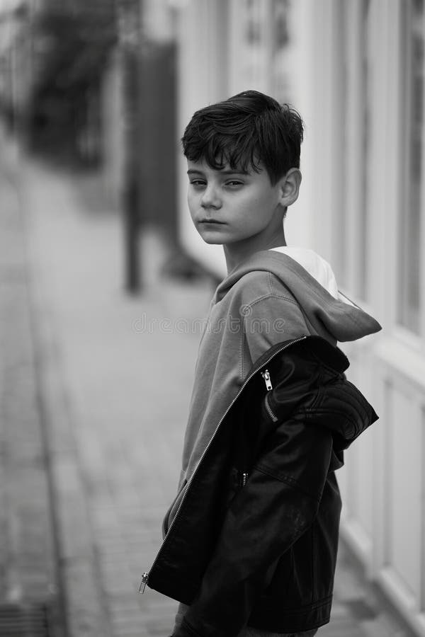 Teenager Boy in Hoodie and Leather Jacket Walks Away on the City Street ...