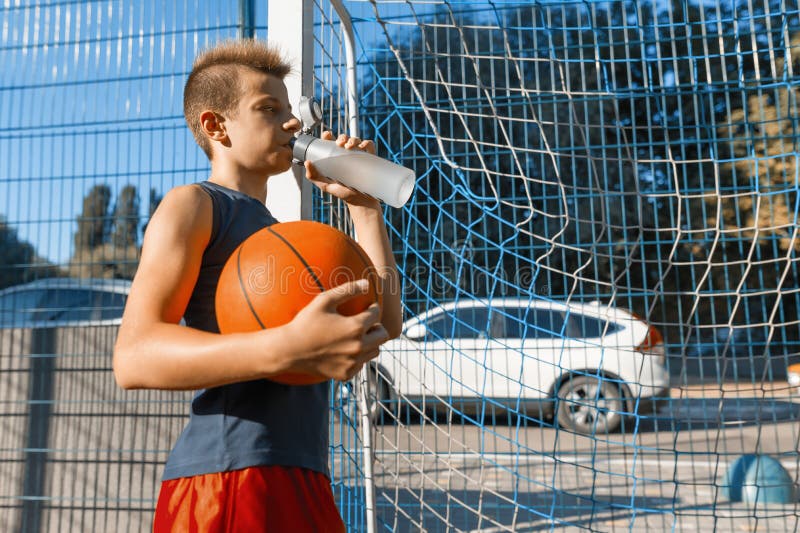 Teen boy with water, Stock image