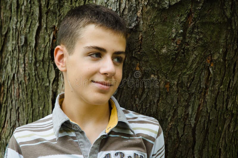 Teenager boy relaxing in a park