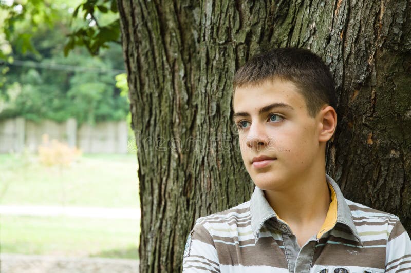 Teenager boy relaxing in a park