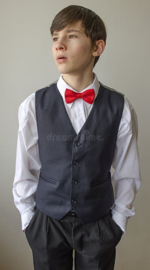 Teenager Boy In A White Shirt And A Waistcoat With The Red Bow Tie ...