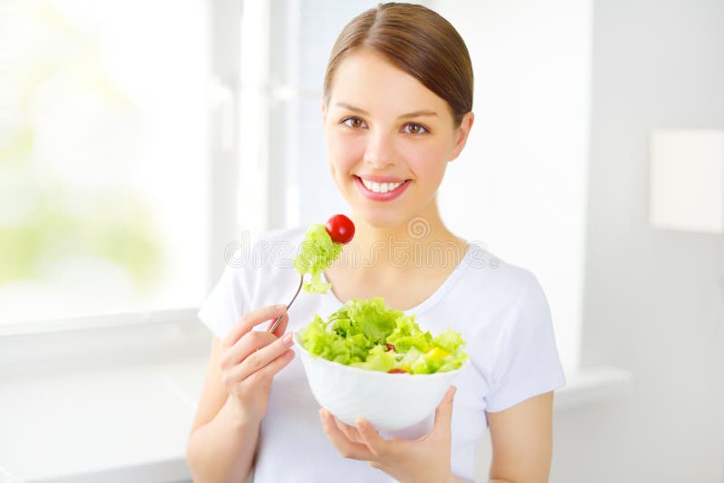 Teenager girl eating salad