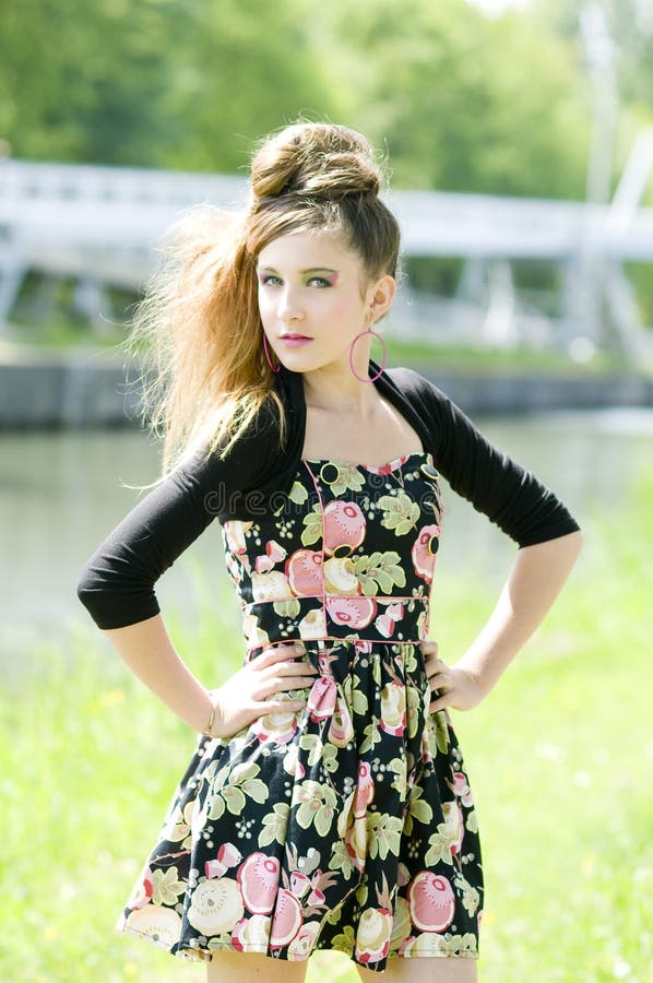 Teenager girl model presenting clothes in the park