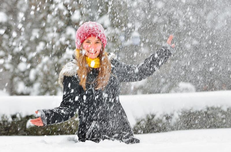 Teenager girl play with snow