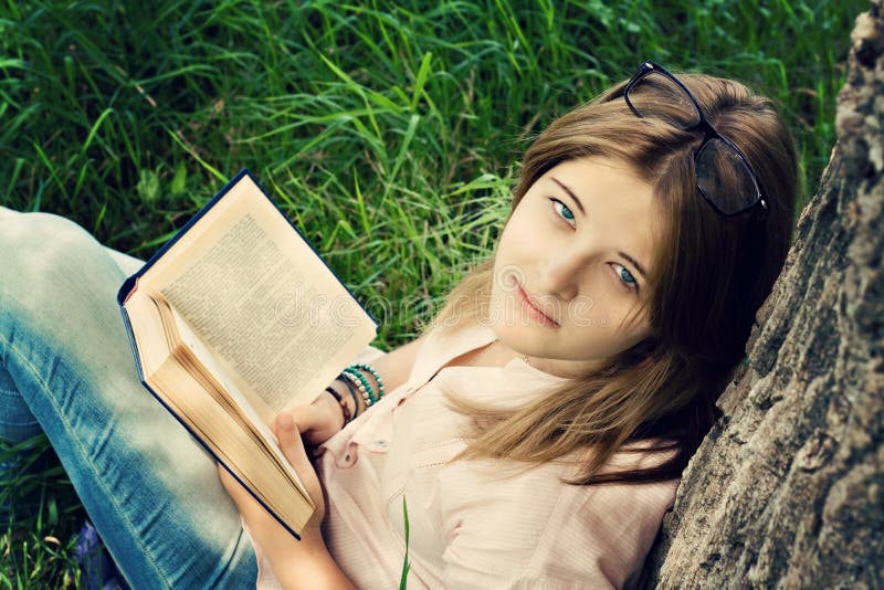 Teenager girl reading book