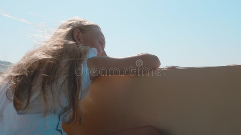 Teenager girl relaxing on sea walk on speed boat at sunny day. Young girl sailing on sea boat on green mountain