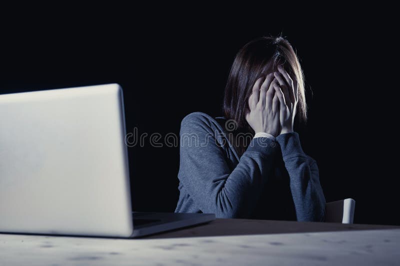 Teenager girl suffering cyberbullying scared and depressed exposed to cyber bullying and internet harassment feeling sad and vulnerable in internet stalker danger and abuse problem
