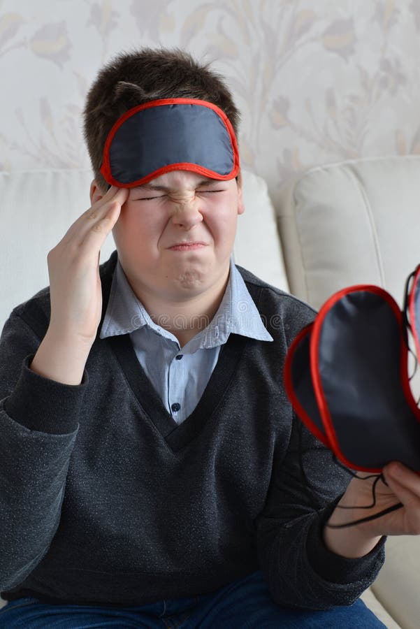 A Teenager with a Headache in Mask for Sleep Stock Photo Image of