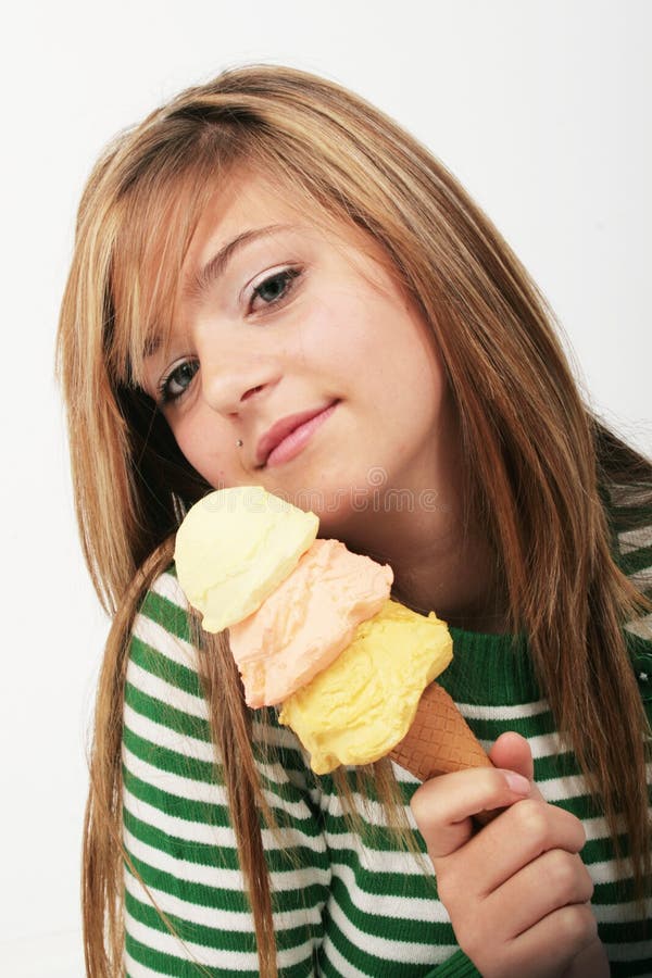 Young woman wearing a green striped sweater having ice cream cone. Young woman wearing a green striped sweater having ice cream cone.