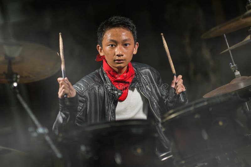 Teenager rock band musician . 13 or 14 years old cool and talented Asian American mixed ethnicity boy playing drums in leather royalty free stock photos Teenager rock band musician . 13 or 14 years old cool and talented Asian American mixed ethnicity boy playing drums in leather royalty free stock photos