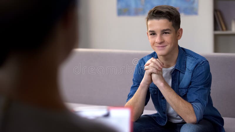 Teenager visiting psychotherapist, successful drug addiction rehabilitation, stock photo