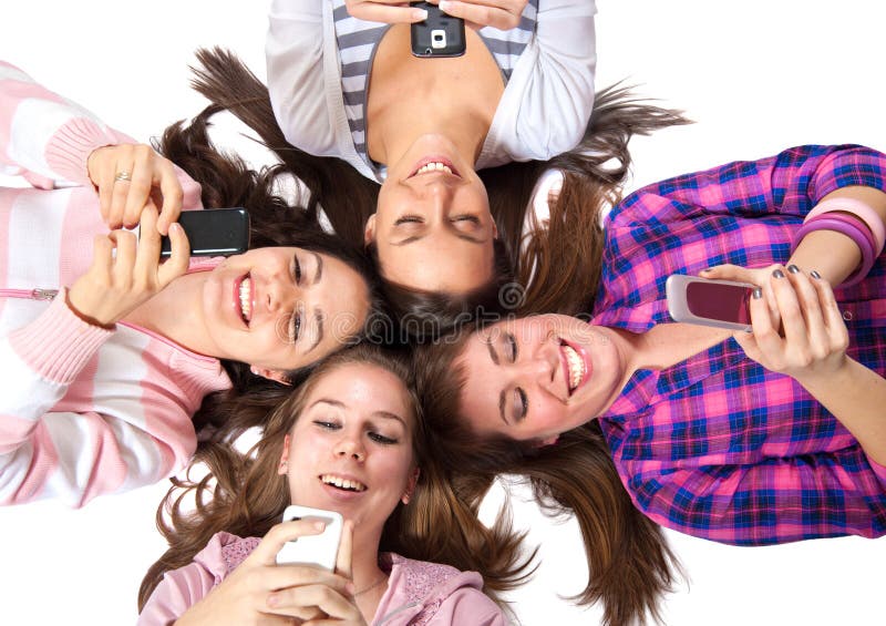 Teenagers lying on white with cellphones smiling