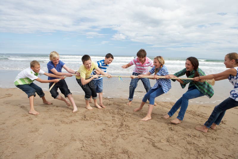 Teenagers playing tug of war having fun