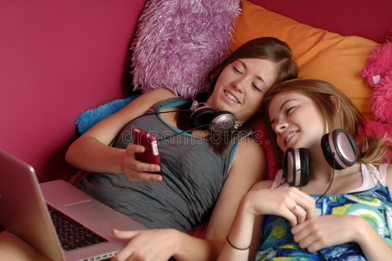 Teens using mobile phone and computer