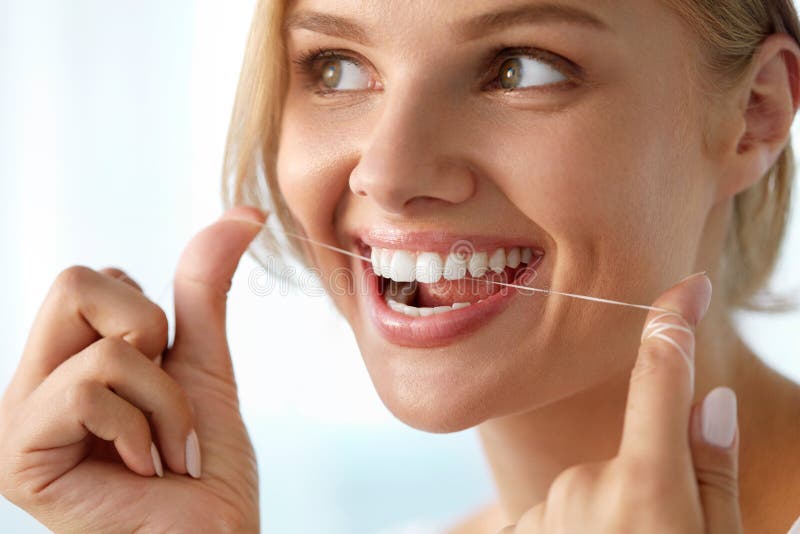 Teeth Care. Beautiful Smiling Woman Flossing Healthy White Teeth royalty free stock images Teeth Care. Beautiful Smiling Woman Flossing Healthy White Teeth royalty free stock images