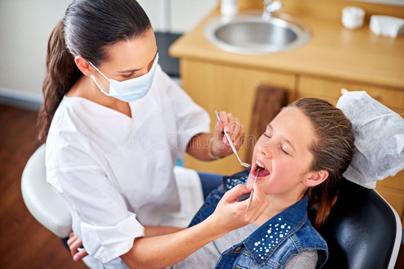 The Teeth Expert. Shot of a Female Dentist Examining a Little Girls