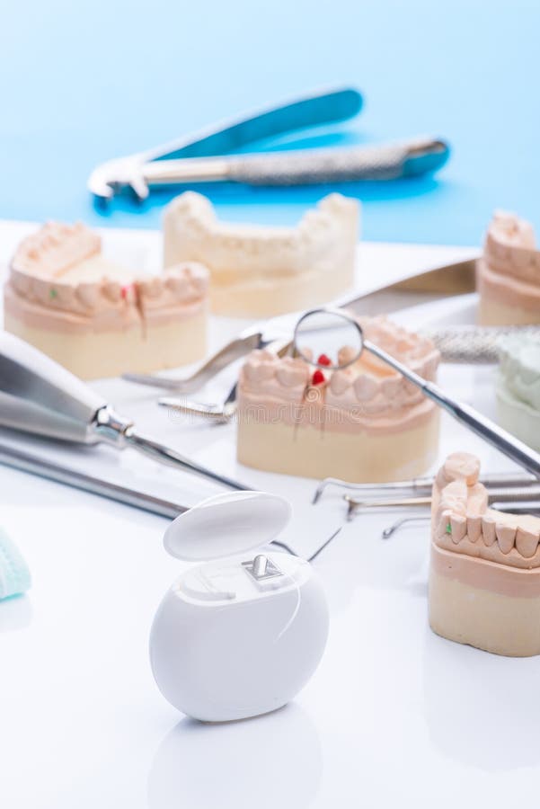 Teeth mold and basic dental tools on white table stock photo Teeth mold and basic dental tools on white table stock photo