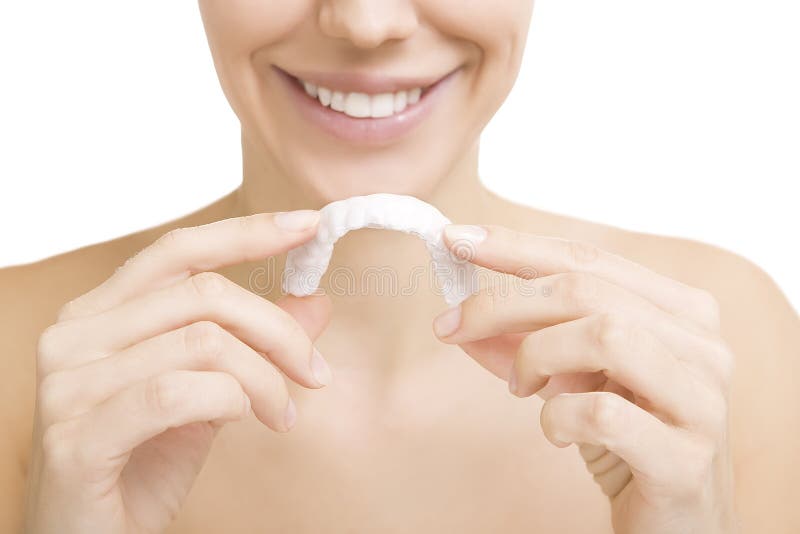 Beautiful smiling girl with tooth tray (hands holding individual tooth tray). Beautiful smiling girl with tooth tray (hands holding individual tooth tray)