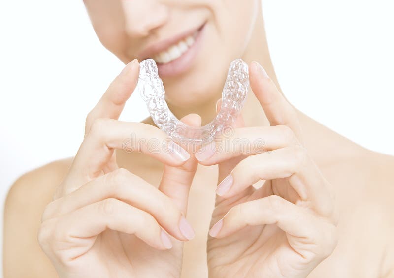 Beautiful smiling girl with tooth tray (hands holding individual tooth tray). Beautiful smiling girl with tooth tray (hands holding individual tooth tray)