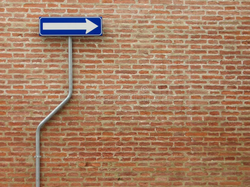 One way sign over a bricks wall - horizontal image. One way sign over a bricks wall - horizontal image
