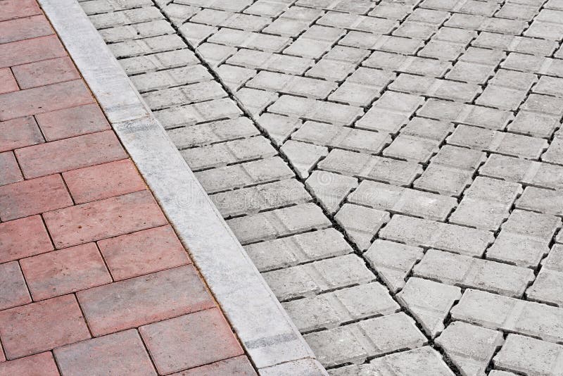 Brick paving types with pink sidewalk, curb and drive made from plain interlocking concrete bricks. Brick paving types with pink sidewalk, curb and drive made from plain interlocking concrete bricks