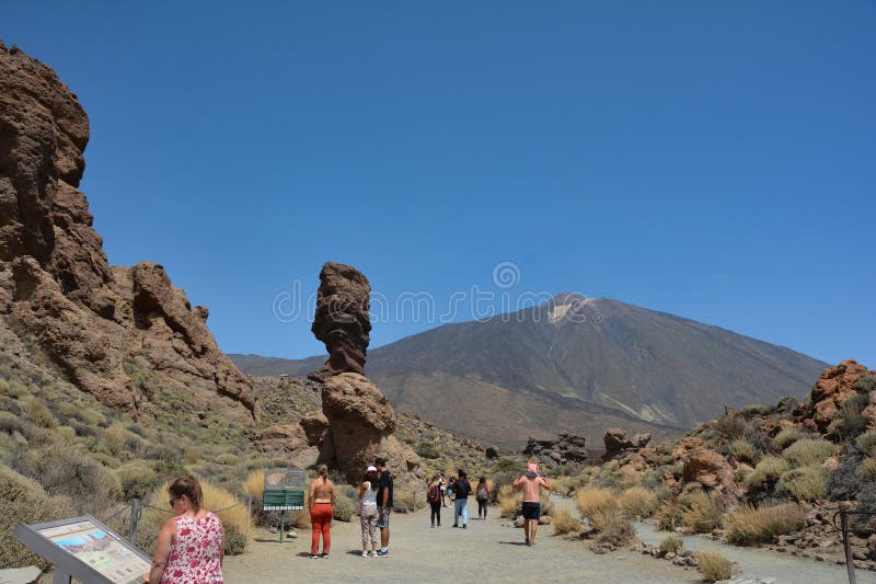 Teide National Park, Tenerife, Spain August 13, 2022 - The bizarrely shaped Roque Cinchado rock of volcanic rock in Teide National Park on the Canary island of Tenerife, Spain. With views of Mount Teide and blue skies. Teide National Park, Tenerife, Spain August 13, 2022 - The bizarrely shaped Roque Cinchado rock of volcanic rock in Teide National Park on the Canary island of Tenerife, Spain. With views of Mount Teide and blue skies