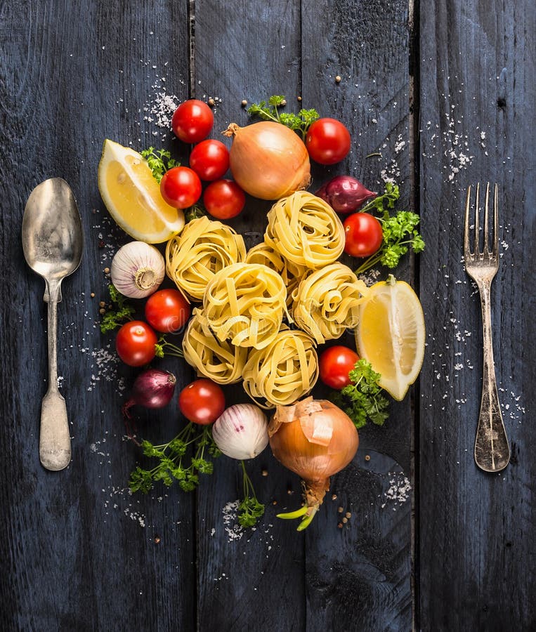 Teigwarenbandnudeln mit Tomaten, Gemüse und Gewürzen für Tomatensauce, Löffel und Gabel lizenzfreies stockbild Teigwarenbandnudeln mit Tomaten, Gemüse und Gewürzen für Tomatensauce, Löffel und Gabel lizenzfreies stockbild