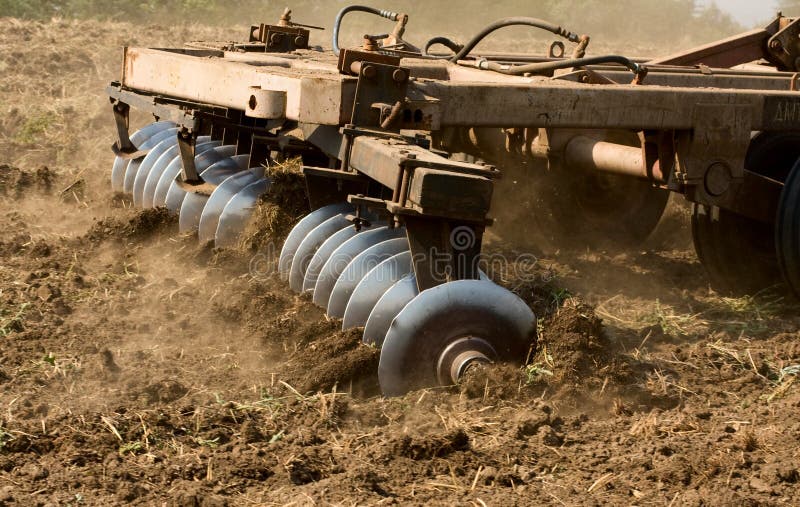 Agricultural tractor cultivating land in Russia. Agricultural tractor cultivating land in Russia