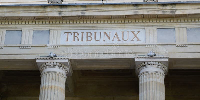 A tribunaux text on ancient facade door entrance building means in french law courts tribunal. A tribunaux text on ancient facade door entrance building means in french law courts tribunal