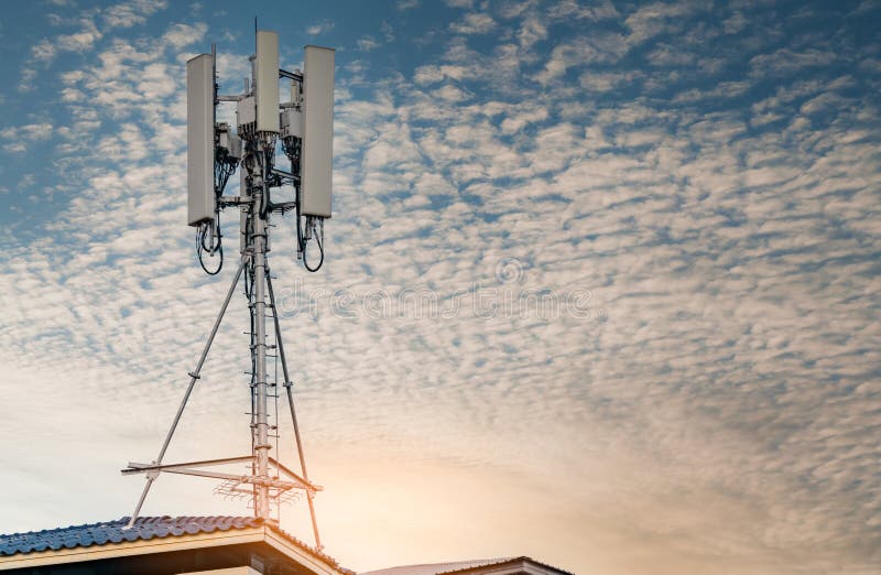 Telecommunication tower with blue sky and white clouds background. Antenna on blue sky. Radio and satellite pole. Communication