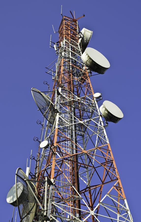 Telecommunication towers against blue sky stock image