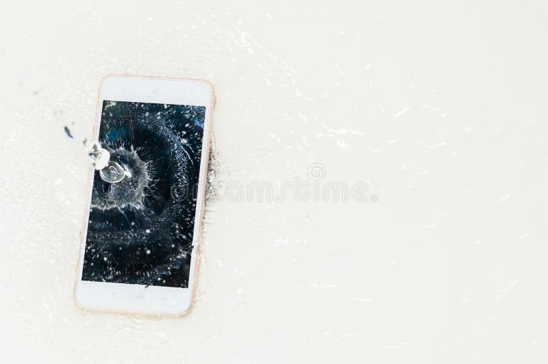 Phone dropped into the water. Telephone and water drops. Close up. Phone dropped into the water. Telephone and water drops. Close up