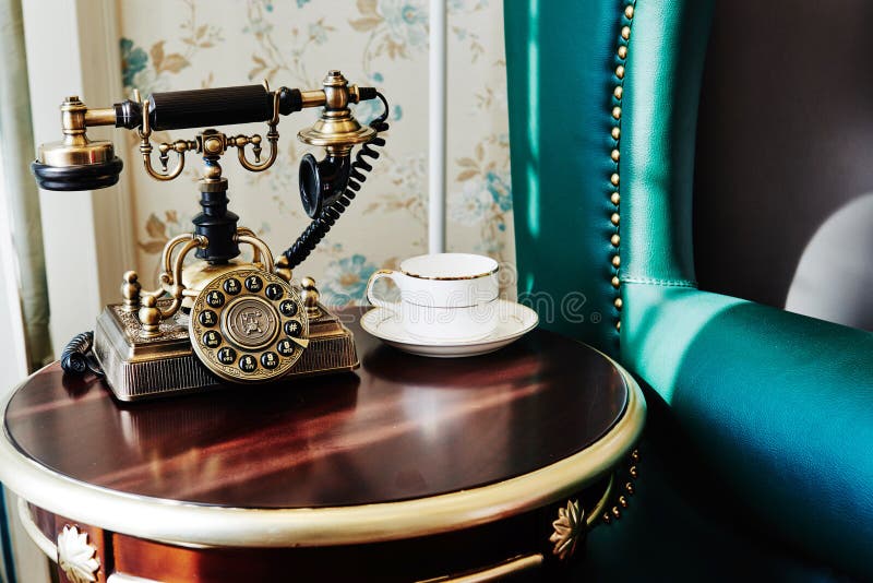 Old vintage telephone set is on the table in rest room. Old vintage telephone set is on the table in rest room