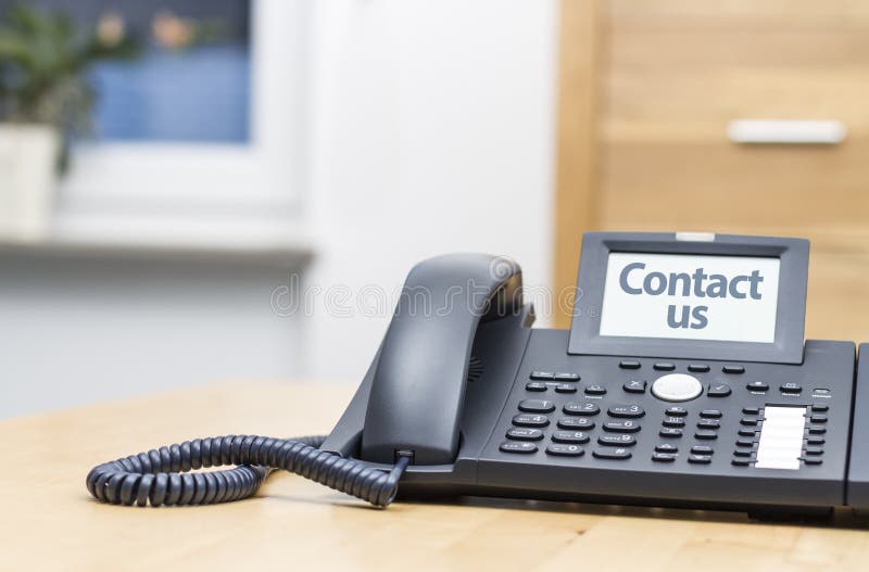Telephone with digital display on wooden desk stock image