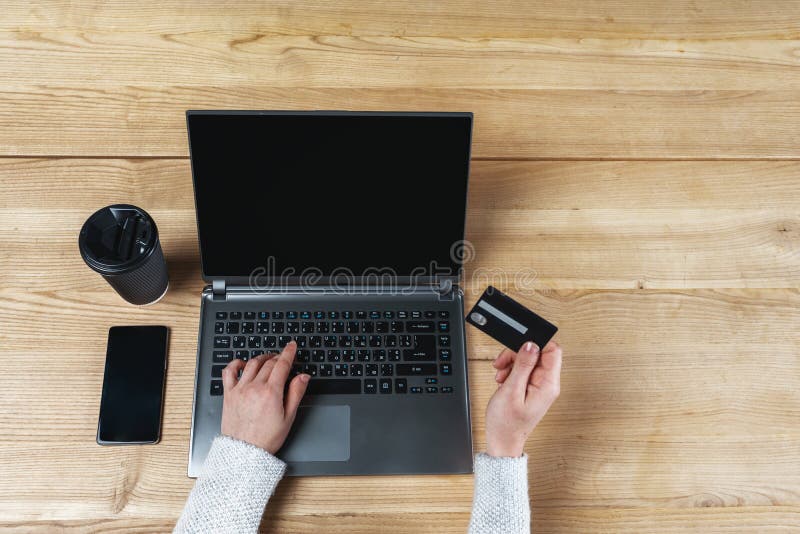 Telephone equipment and coffee on wooden table. Woman shopping online royalty free stock photography Telephone equipment and coffee on wooden table. Woman shopping online royalty free stock photography