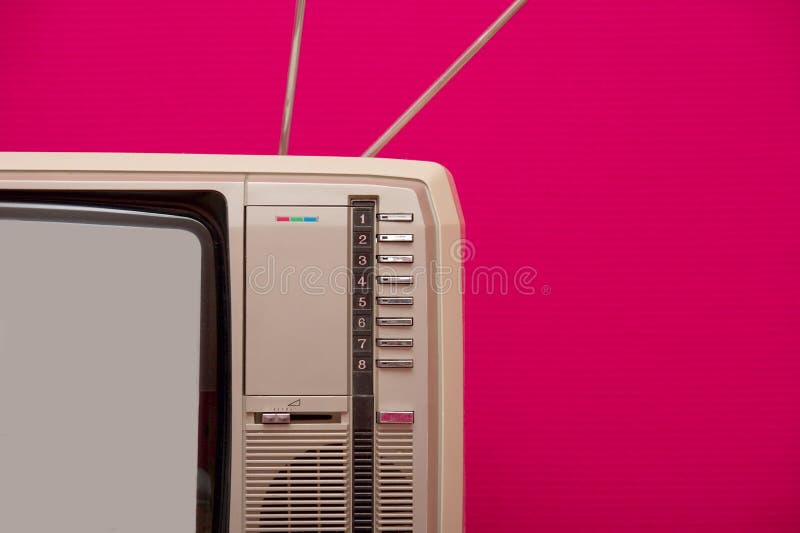 Detail of an old vintage tv set against pink wall. Detail of an old vintage tv set against pink wall