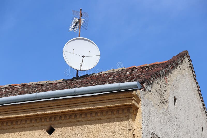 Television antennas on the roof of an old house royalty free stock photos