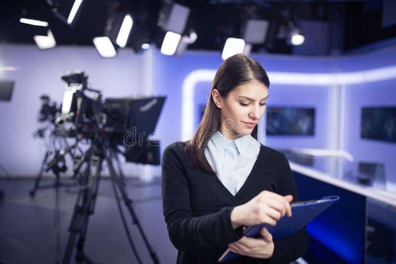 Television presenter recording in news studio.Female journalist anchor presenting business report. Broadcast, breaking.