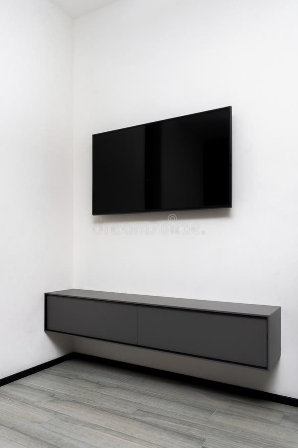 Television on White Wall and Shelf in Living Room Stock Photo Image