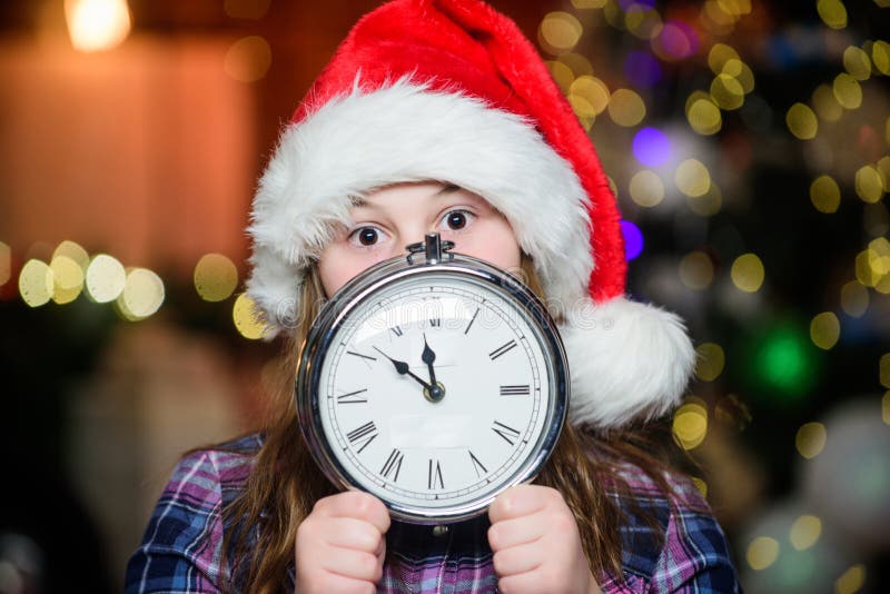Teltijd Minder minuten tot nieuw jaar Magisch moment komt eraan Bijna Kerstmis hier Girl santa claus hat and klok stock foto's Teltijd Minder minuten tot nieuw jaar Magisch moment komt eraan Bijna Kerstmis hier Girl santa claus hat and klok stock foto's