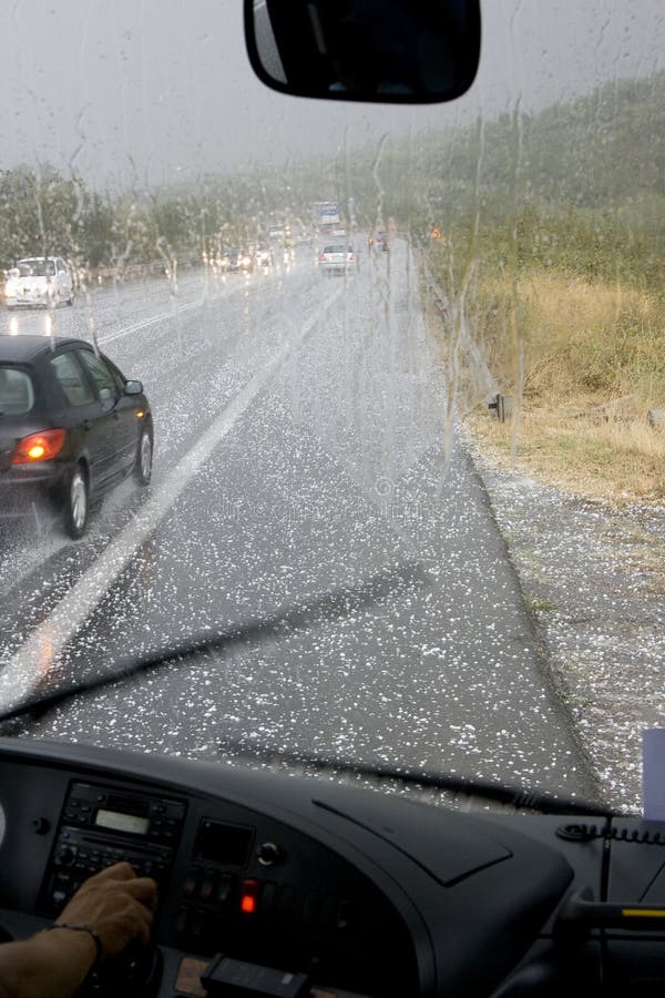 Driving in a dangerous road during a hail storm in Greece. Driving in a dangerous road during a hail storm in Greece