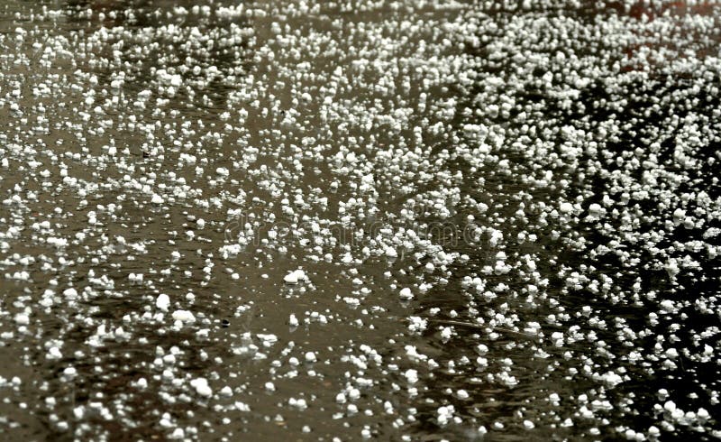 Hail storm on the city streets in Italy . ice balls details on the pavement. Hail storm on the city streets in Italy . ice balls details on the pavement